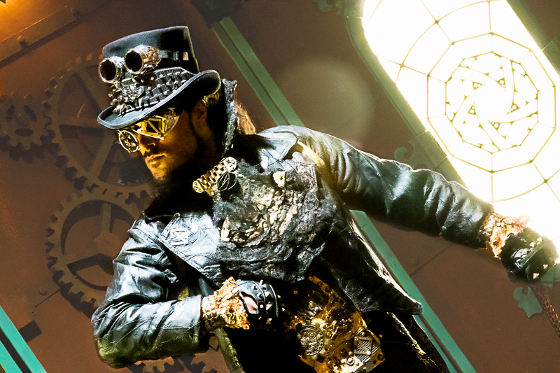 Steampunk portrait — side profile showing elaborate headwear and pocket watch